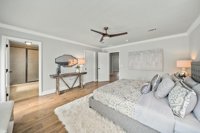 bedroom with crown molding, ceiling fan, and hardwood / wood-style floors