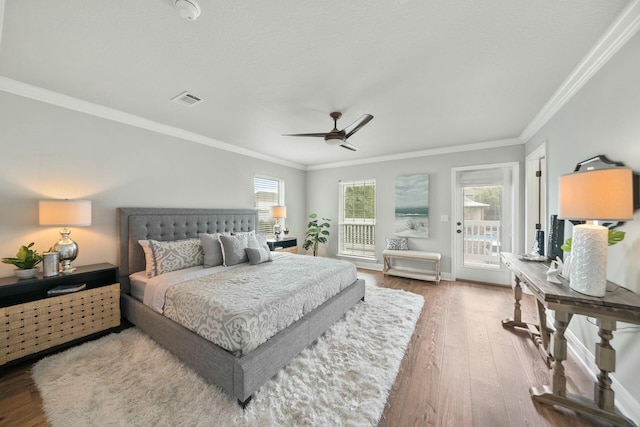 bedroom with multiple windows, crown molding, access to exterior, and ceiling fan