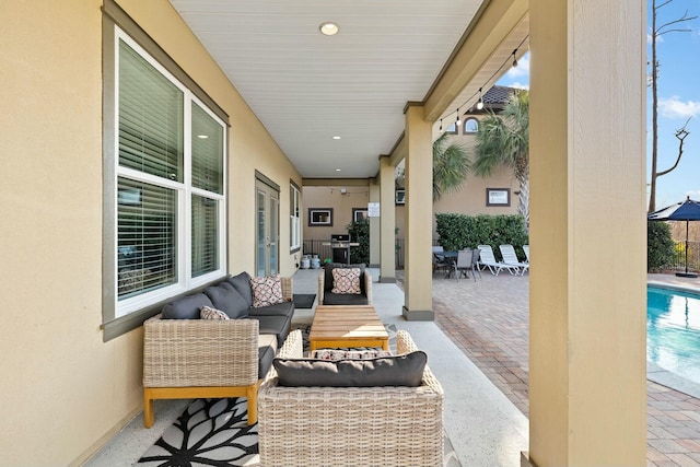 view of patio with an outdoor living space and a fenced in pool