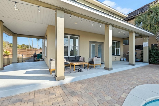 view of patio / terrace with an outdoor living space and french doors