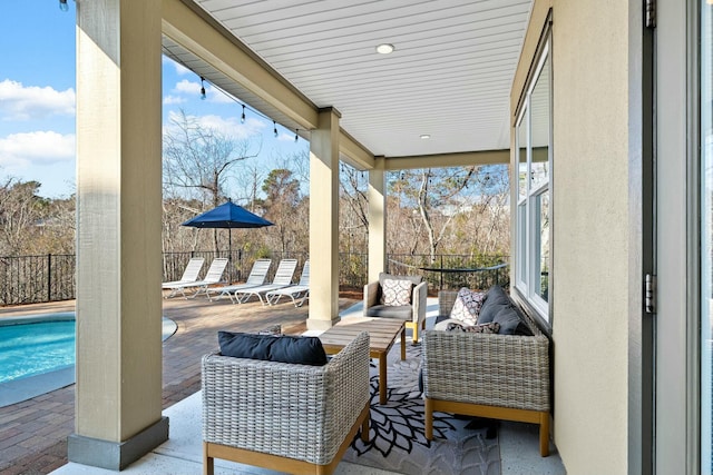 view of patio / terrace with an outdoor living space and a fenced in pool