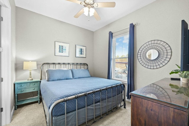 bedroom featuring ceiling fan and light carpet