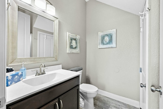 bathroom featuring hardwood / wood-style flooring, vanity, and toilet