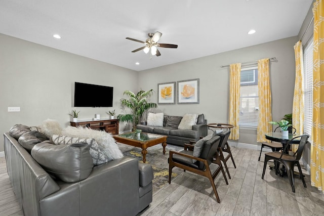 living room featuring light hardwood / wood-style floors and ceiling fan