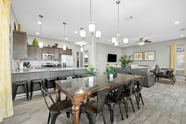 dining room with ceiling fan and light hardwood / wood-style flooring