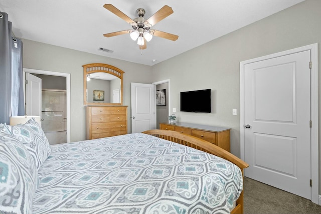 carpeted bedroom featuring ceiling fan and ensuite bath