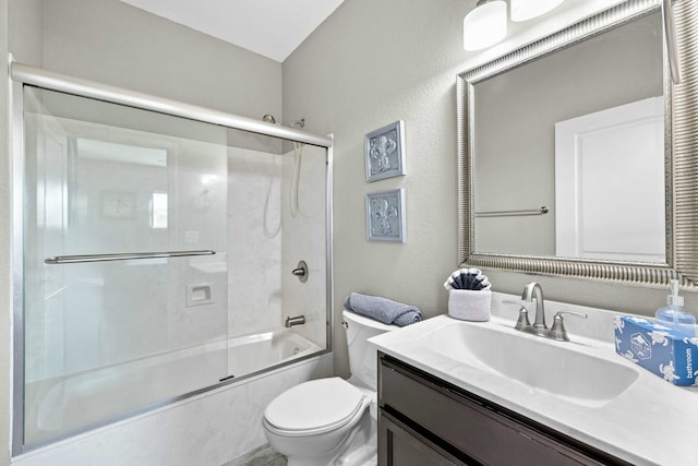 full bathroom featuring vanity, toilet, and combined bath / shower with glass door