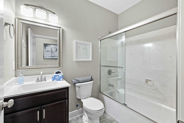 full bathroom with vanity, shower / bath combination with glass door, and toilet