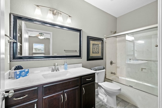 full bathroom with ceiling fan, vanity, toilet, and combined bath / shower with glass door