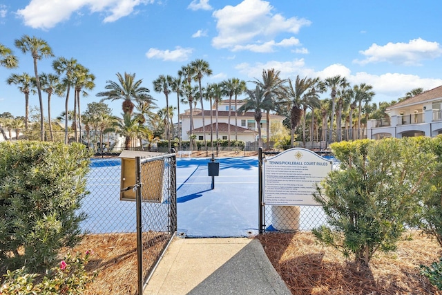 view of swimming pool with tennis court