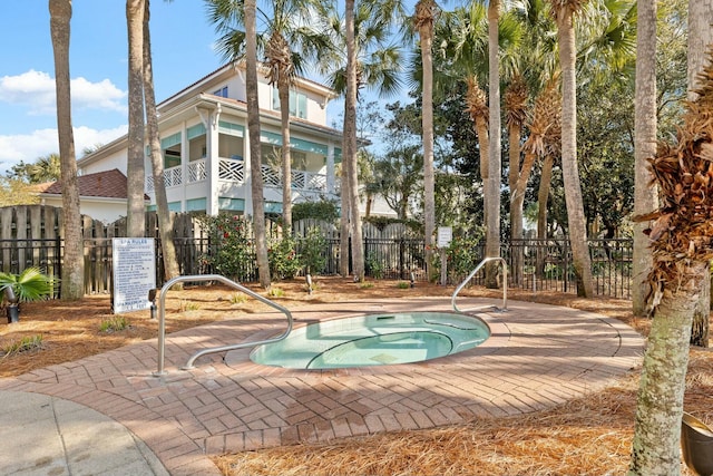 view of swimming pool with a community hot tub