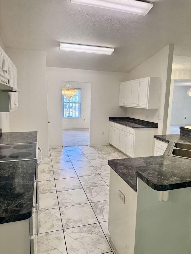 kitchen featuring electric stove, marble finish floor, white cabinetry, and a sink