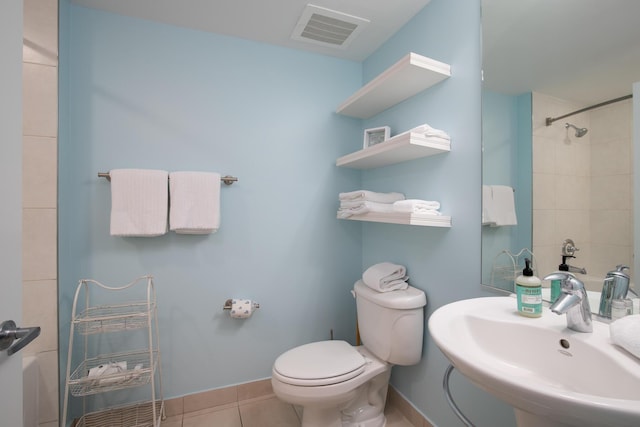 bathroom featuring toilet, tile patterned flooring, and sink