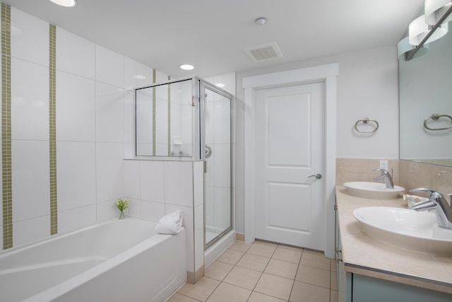 bathroom with vanity, shower with separate bathtub, tile patterned flooring, and tile walls