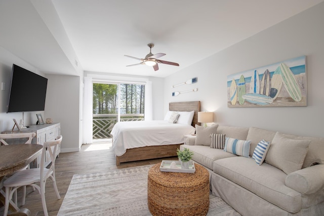 bedroom featuring ceiling fan, access to outside, and light wood-type flooring