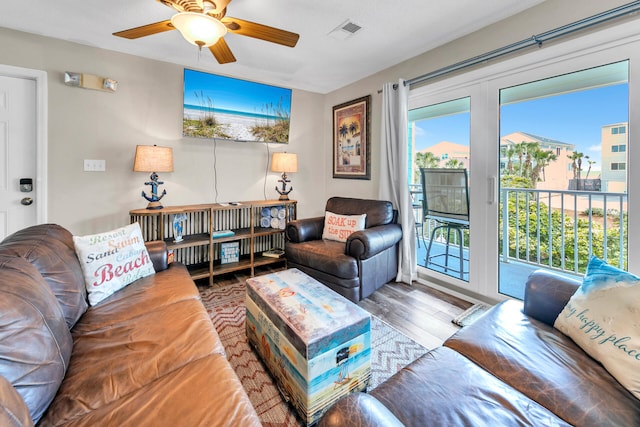 living room featuring hardwood / wood-style floors and ceiling fan