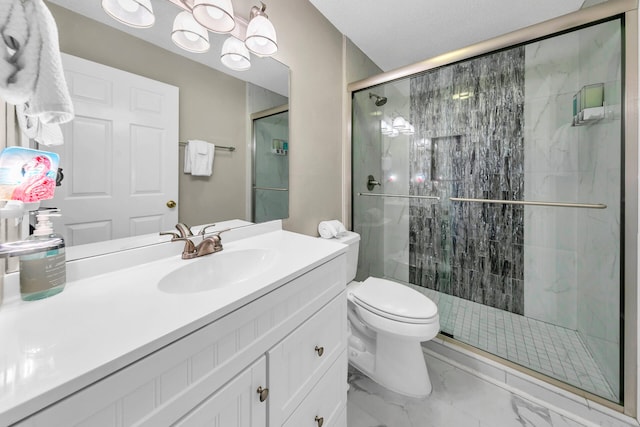 bathroom with vanity, a shower with shower door, and toilet