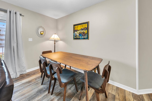 dining space with hardwood / wood-style floors