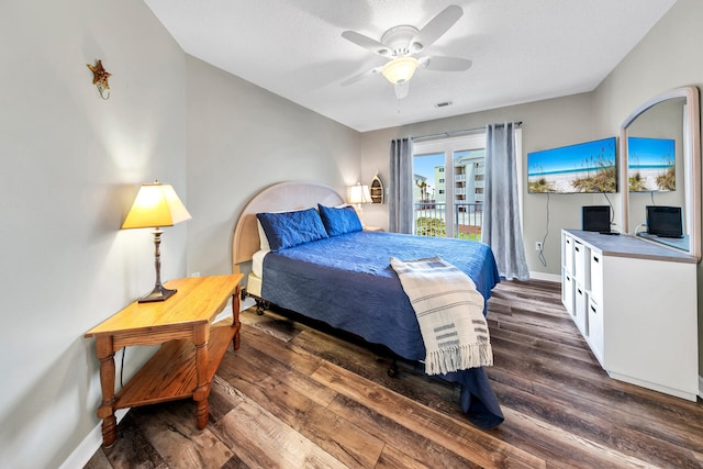 bedroom with dark wood-type flooring, a textured ceiling, access to exterior, and ceiling fan