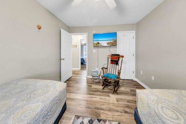 bedroom with hardwood / wood-style floors and ceiling fan