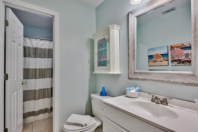 bathroom featuring tile patterned floors, toilet, a textured ceiling, vanity, and a shower with shower curtain