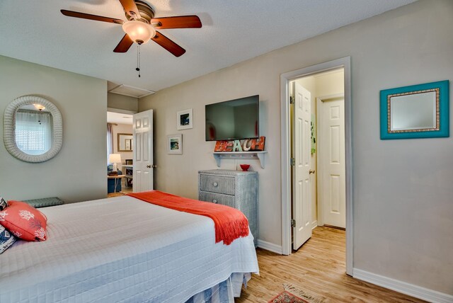 bedroom with light wood-type flooring and ceiling fan