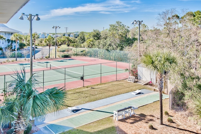 view of tennis court with a lawn