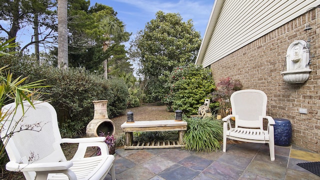 view of patio / terrace featuring an outdoor fireplace