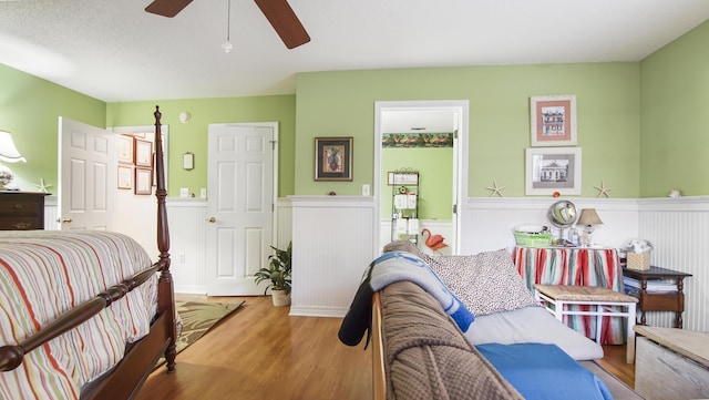 bedroom with wood-type flooring and ceiling fan