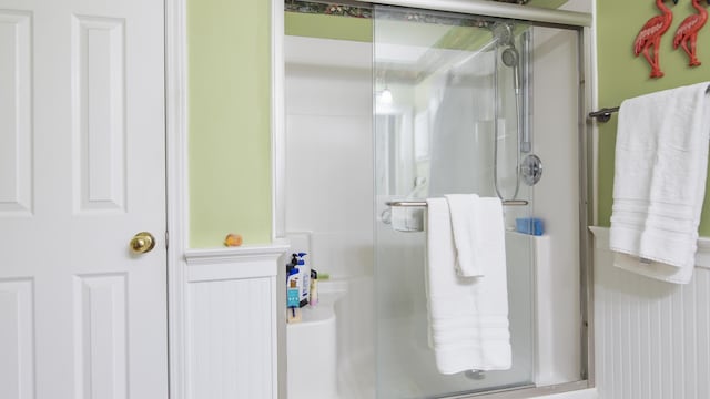 bathroom with a shower with shower door