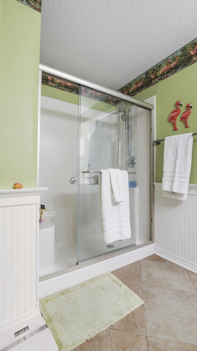 bathroom featuring walk in shower and a textured ceiling