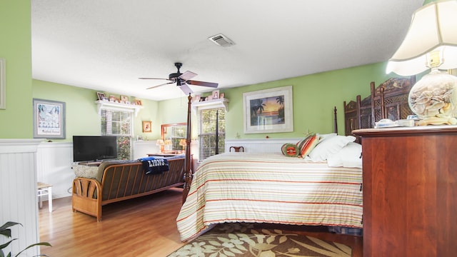 bedroom with hardwood / wood-style flooring and ceiling fan