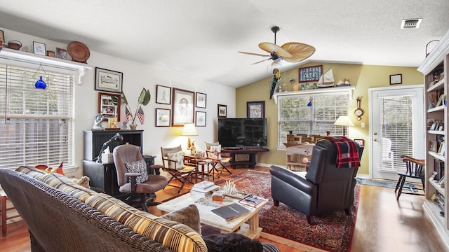 living room with lofted ceiling, a healthy amount of sunlight, hardwood / wood-style floors, and ceiling fan