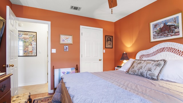 tiled bedroom with ceiling fan