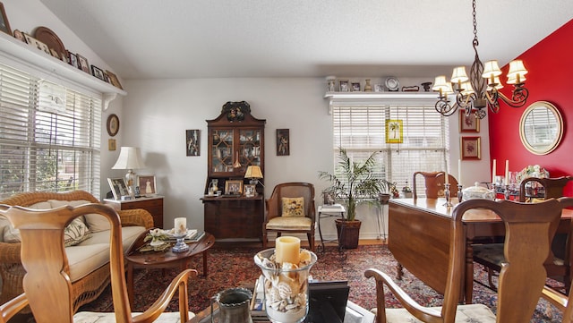 dining area featuring a textured ceiling, vaulted ceiling, and a chandelier