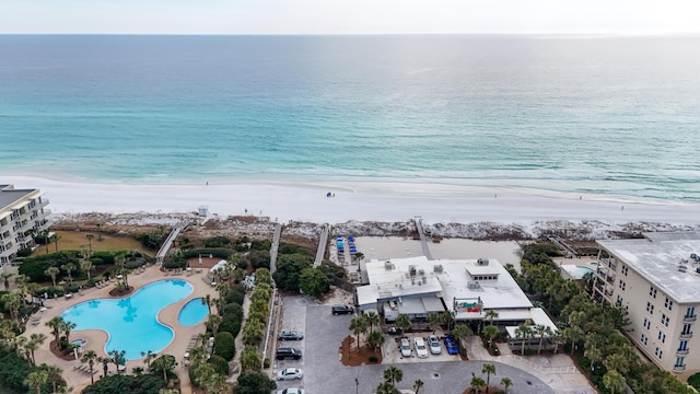 bird's eye view with a water view and a beach view