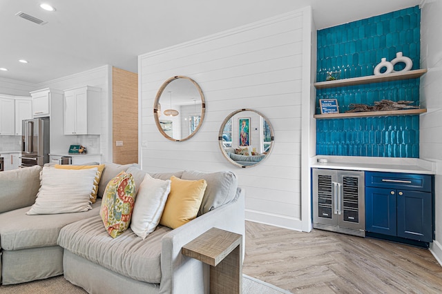 living room with light parquet flooring and beverage cooler