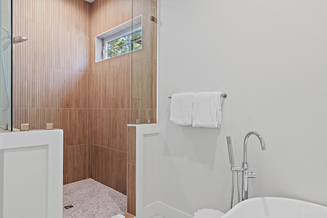 bathroom featuring independent shower and bath