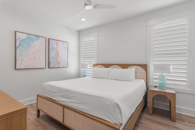 bedroom with light hardwood / wood-style floors and ceiling fan