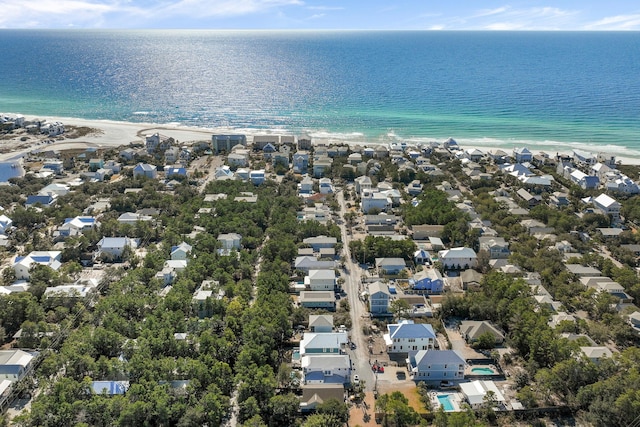 bird's eye view with a water view and a beach view