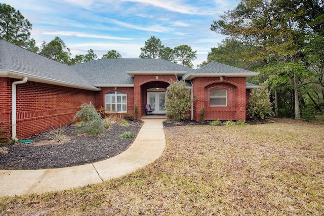 6568 Castlewood St, Navarre, FL 32566 - ranch-style home with a front yard and french doors