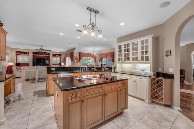 6568 Castlewood St, Navarre, FL 32566 - kitchen with a center island, black electric cooktop, kitchen peninsula, pendant lighting, and ceiling fan with notable chandelier