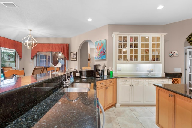 6568 Castlewood St, Navarre, FL 32566 - kitchen featuring pendant lighting, sink, dark stone counters, light tile patterned floors, and an inviting chandelier
