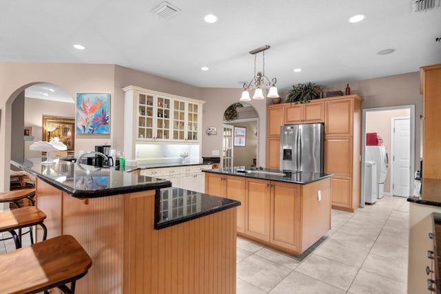 6568 Castlewood St, Navarre, FL 32566 - kitchen featuring stainless steel fridge, a center island, separate washer and dryer, decorative light fixtures, and kitchen peninsula