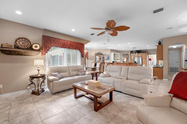 6568 Castlewood St, Navarre, FL 32566 - living room with light tile patterned flooring, a textured ceiling, and ceiling fan