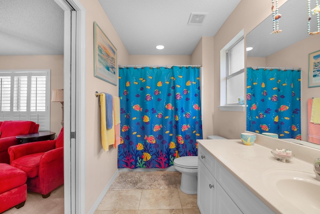 6568 Castlewood St, Navarre, FL 32566 - bathroom with tile patterned floors, toilet, vanity, and a textured ceiling