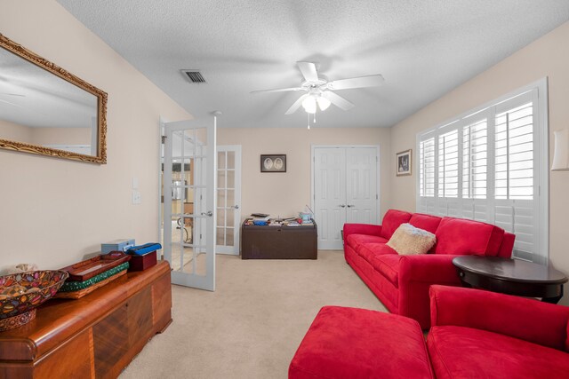 6568 Castlewood St, Navarre, FL 32566 - living room with light carpet, a textured ceiling, ceiling fan, and french doors