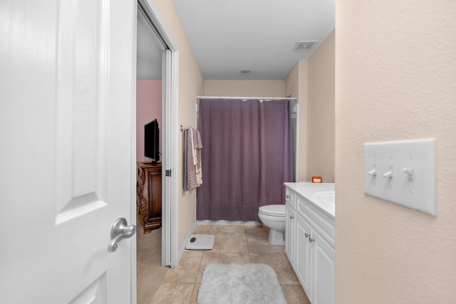 6568 Castlewood St, Navarre, FL 32566 - bathroom with vanity, a textured ceiling, a shower with curtain, tile patterned floors, and toilet