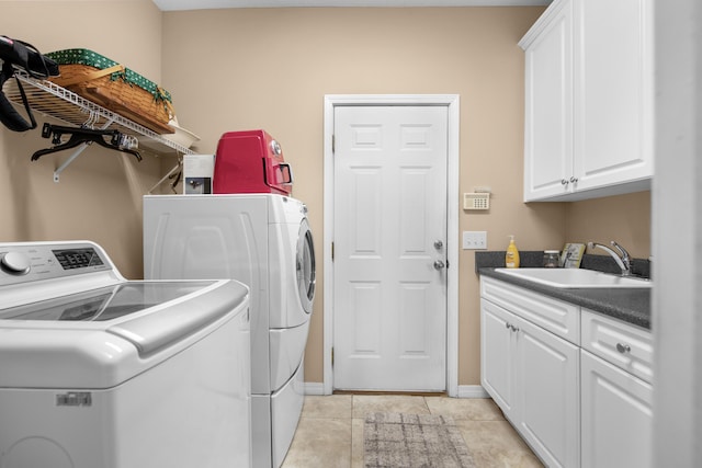 6568 Castlewood St, Navarre, FL 32566 - laundry area with cabinets, separate washer and dryer, sink, and light tile patterned floors