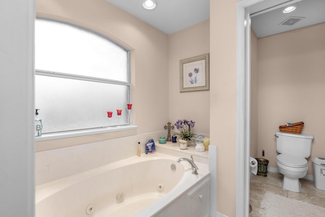 6568 Castlewood St, Navarre, FL 32566 - bathroom featuring tile patterned floors, toilet, and a tub